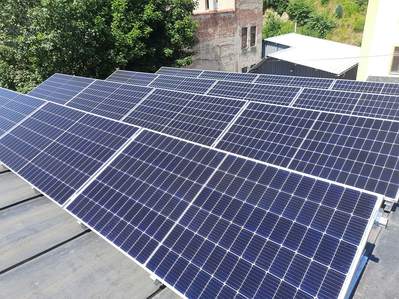 Řady fotovoltaických panelů na střeše provozovny